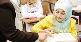 female teaching quran to a child